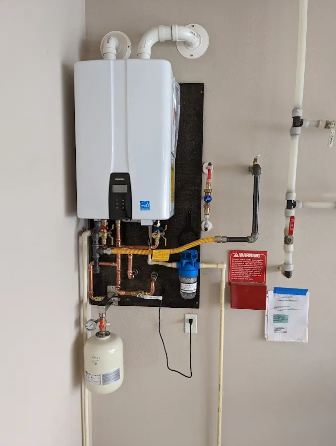 Professional plumber installing copper piping in a Harwinton home